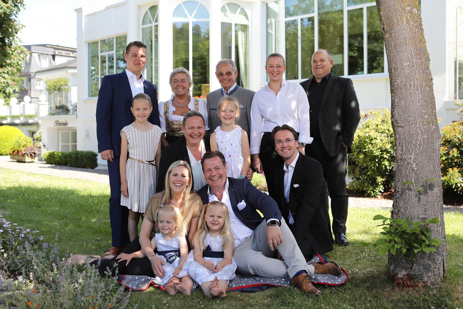 Host family Deimann in summer in the garden on a picnic blanket