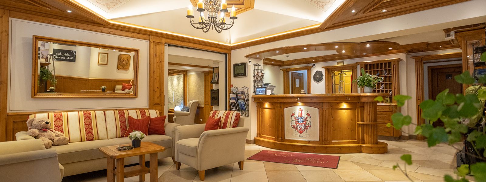 Reception of Hotel Voss; on the left is a seating area with sofa and 2 armchairs