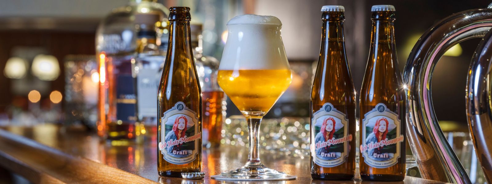Bottles and freshly tapped beer specialty Red Hair Mountain