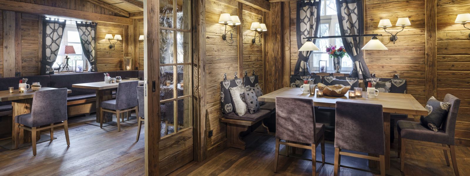 Rustic dining room with wood-paneled walls, country-style furnishings