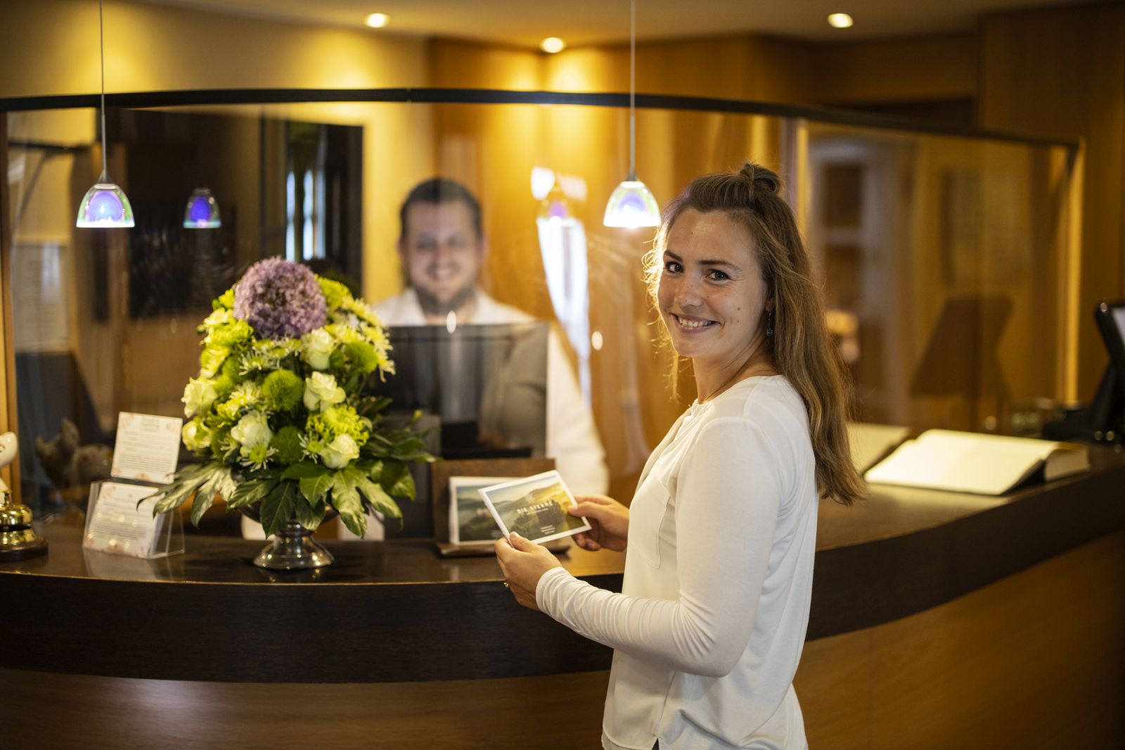 Employee at the reception fills up the &quot;Stars in the Sauerland&quot; brochure