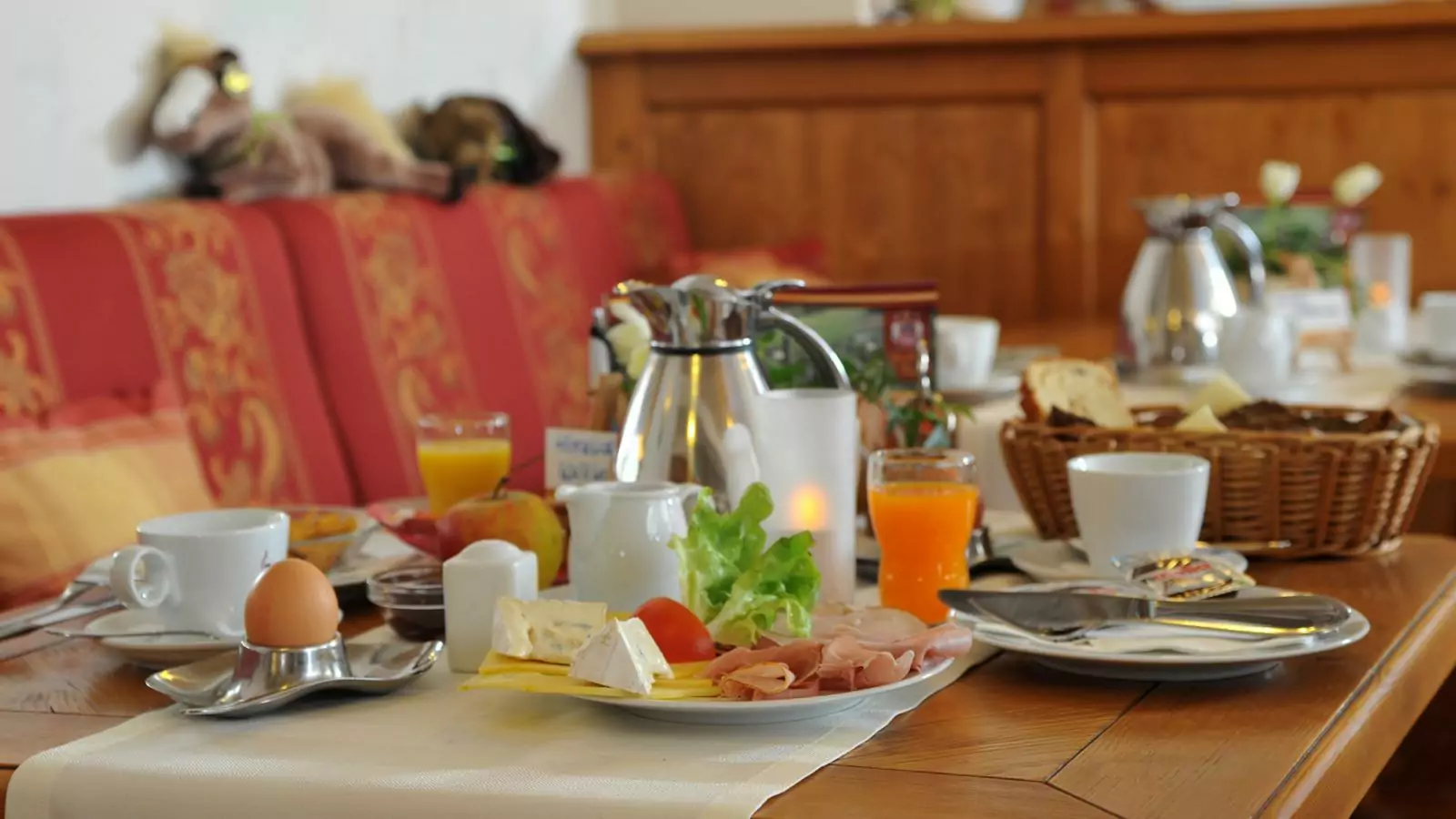 Landhotel Voss – abwechslungsreiches Frühstück Gedeckter Frühstückstisch mit Aufschnitt, Ei, Saft und Kaffee im Hotel Voss